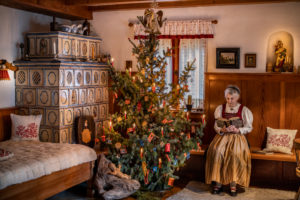Christmas in an idyllic parlor, grandma in traditional costume Christmas in an idyllic parlor, grandma in traditional costume